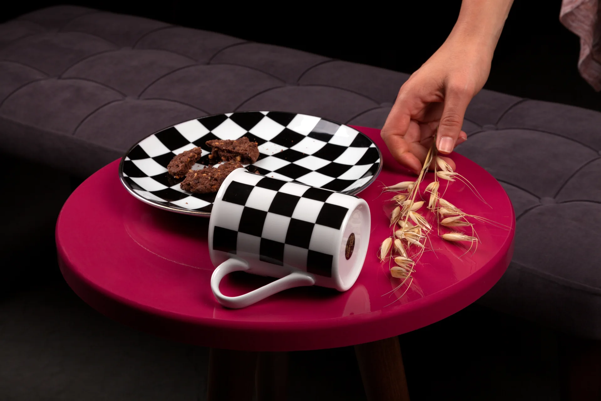 Black and white checked porcelain on a vivid red side table.